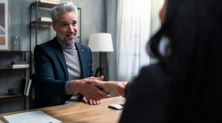 mature-financial-advisor-shaking-hand-with-his-cli-2022-02-02-06-28-43-utc